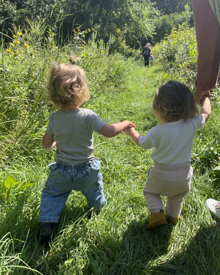Toddlers holding hands walking